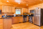 Fully Equipped Kitchen Features Granite Counter Tops and Stainless Steel Appliances